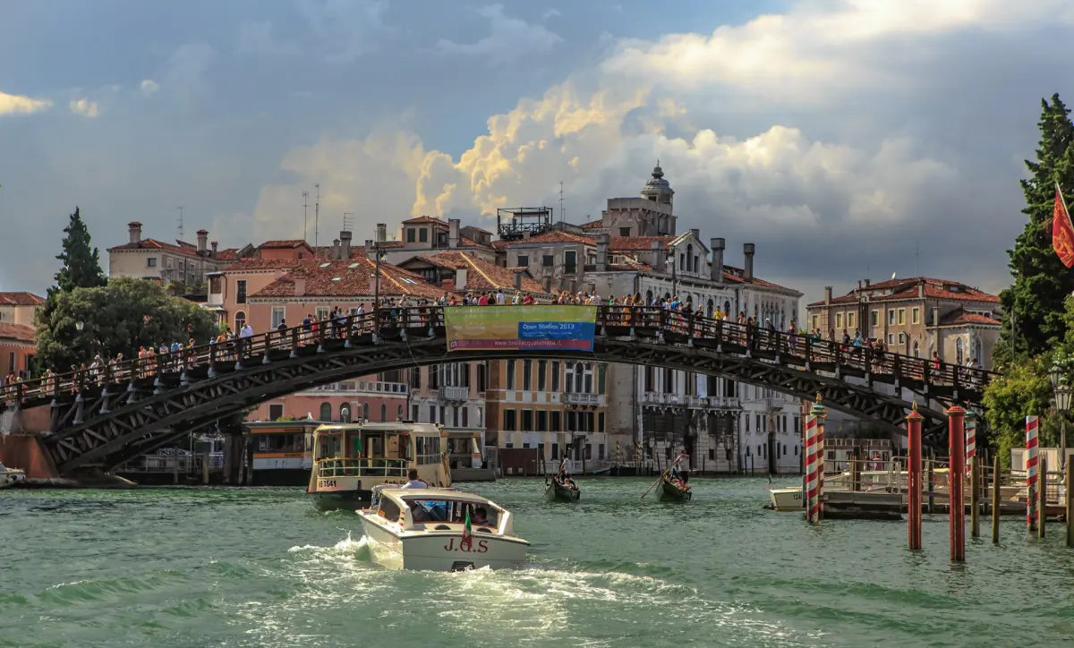 Boats passing under the Accademia Bridge