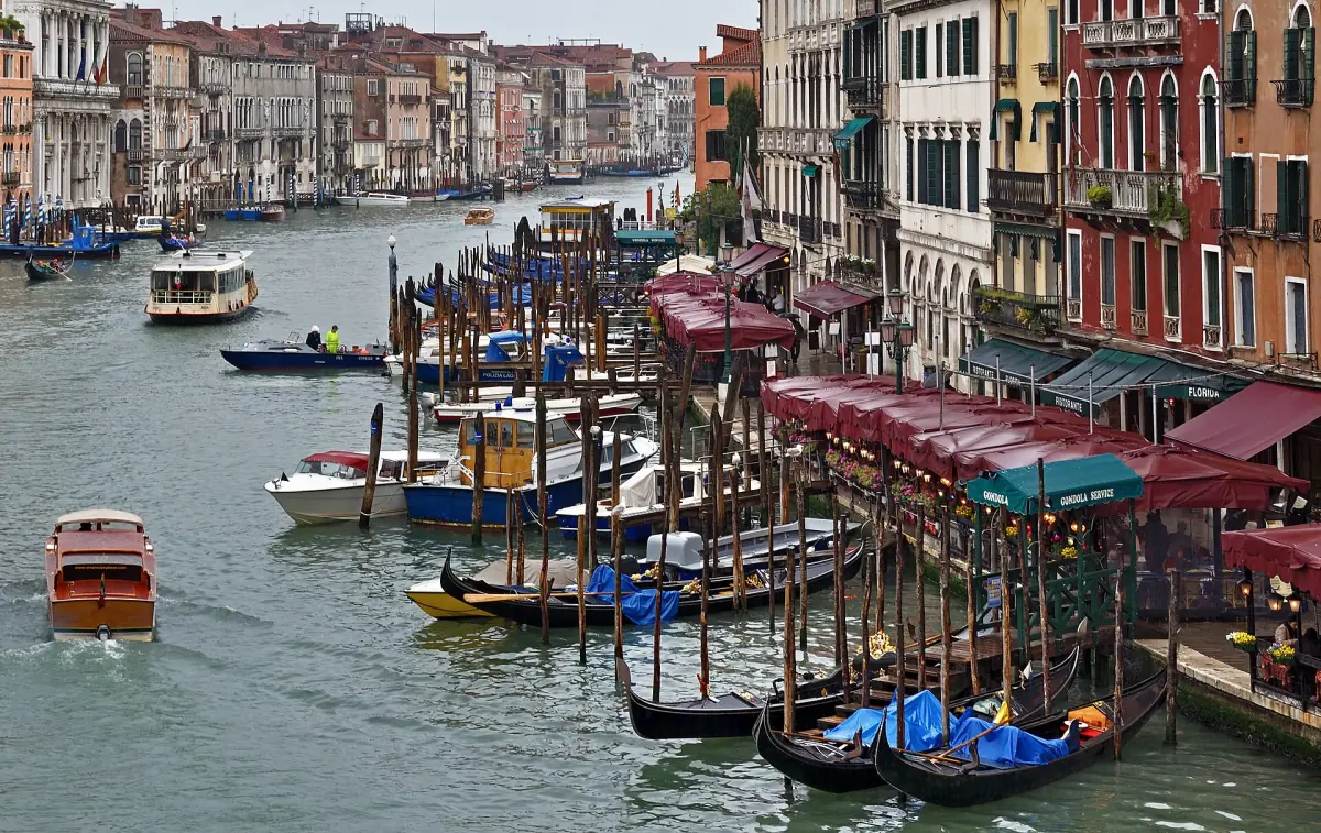 Moored gondolas near the Rialto Bridge on a rainy day